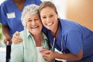Older adult arranging familiar belongings in a bright assisted living apartment with family support.
